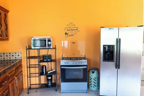 A kitchen with a microwave, stove, and refrigerator. - Natutre Escape Oceanview Oasis   (Hopewell)