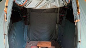 A tent with a central sleeping area and a raised platform. - Cozzy Taman Nyingkur (bandung)