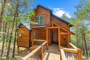 A wooden cabin with a porch, a front door, and a number '240' sign. - Secluded Cabin_Lake Taneycomo View_Peaceful Deck_Bonus Loft_Free Attraction Tickets (Branson)