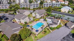 A residential area with multiple two-story houses, a swimming pool, and a parking lot. - CLM 16B  Gorgeous, pet friendly - Private beach access (Destin)