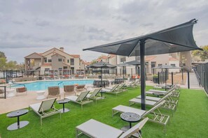 A poolside area with lounge chairs, umbrellas, and a swimming pool. - Desert Oasis Near TPC Poo Balcony Parking WD (Scottsdale)