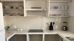 A kitchen with white cabinets, a countertop, a built-in oven, and a sink. - Monthly Beach House Rental in Manzanillo, Mexico – Perfect for Snowbirds (Manzanillo)