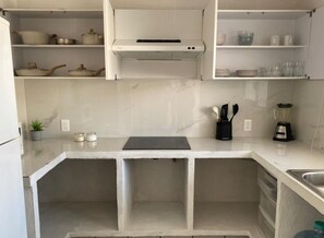 A kitchen with white cabinets, a countertop, a built-in oven, and a sink. - Monthly Beach House Rental in Manzanillo, Mexico – Perfect for Snowbirds (Manzanillo)