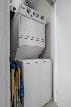 A compact, white Whirlpool washer and dryer unit with a control panel featuring multiple dials and buttons. - Stylish Gold Coast 1BR  Near Beach  Pools & Gym (Noord)