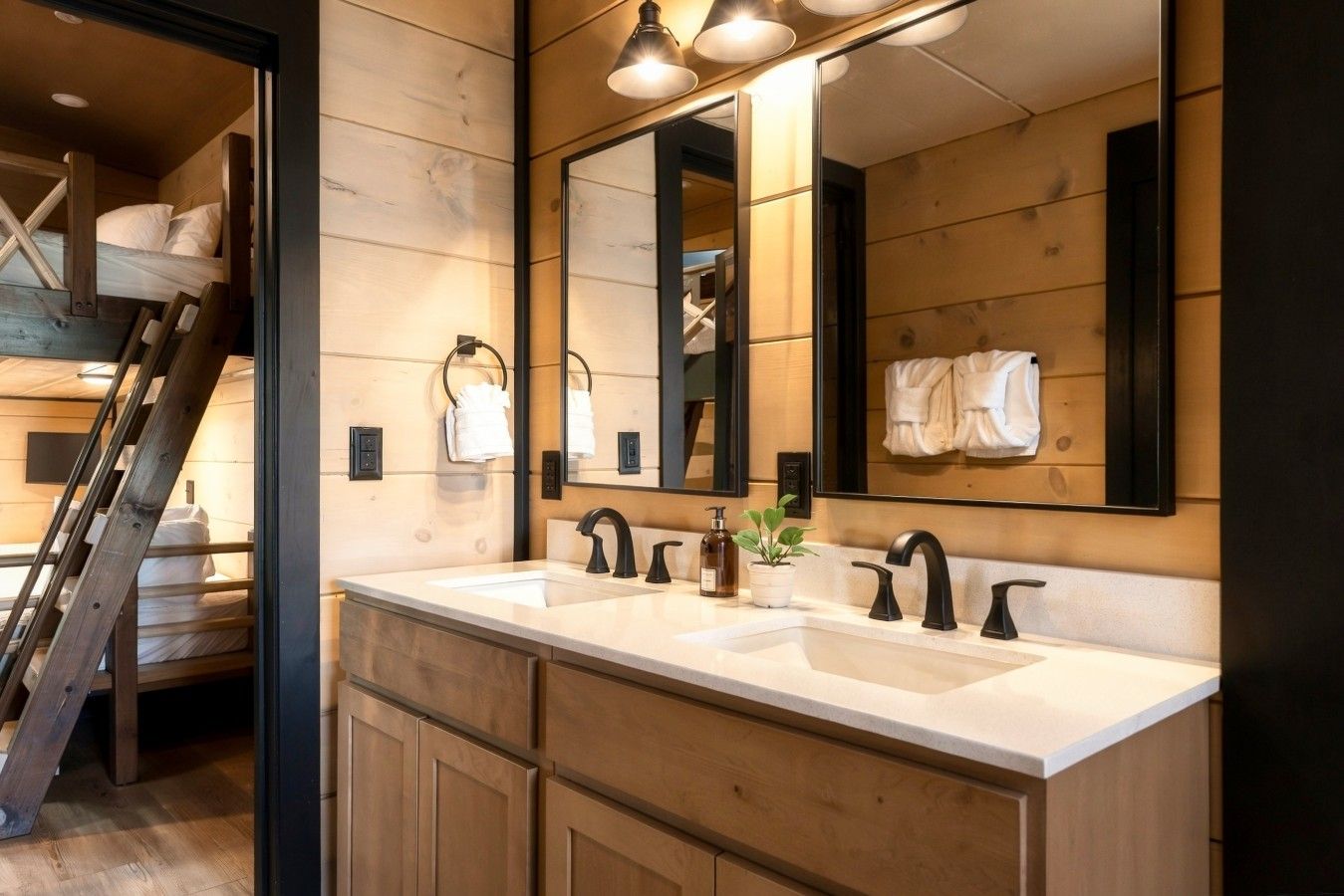 A modern bathroom with a wooden interior, a double sink, and a large mirror.