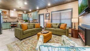 A living room with a sofa set, a coffee table, and a patterned rug. - CampingThemed/Pool/HotTub/GameRoom/FirePit/Sleep16 (Sevierville)