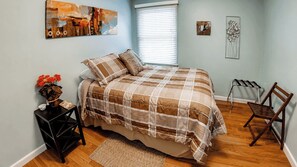 A bedroom with a bed, a nightstand, a chair, and artwork on the walls. - Vin Rouge 51 by Avantstay Sleeps 8 + Hillside Deck + Ping Pong 15-min Walk to Downtown (Paso Robles)