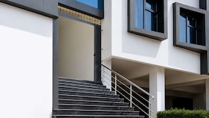 A modern building with a staircase leading to an entrance. - Super Collection O MIDC Pimpari Pune (Pune)