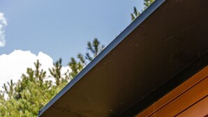 A building with a sloped roof and a window.