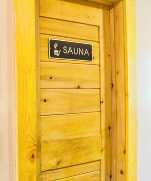 A wooden door with a sign that reads 'SAUNA'. - Historic 4 BR Copper Mine House/ Sauna /Near Trails & Downtown Calumet (Laurium)
