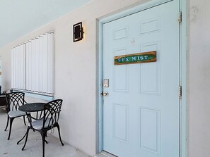 A light blue door with a sign that reads 'SEA MIST' and a small window above it. - THE SEA MIST (Lauderdale-by-the-Sea)