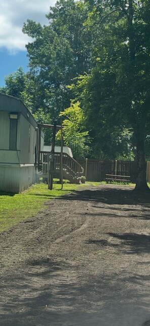 A dirt path leading to a wooden structure with a ramp. - Camp / 1097 Elm run (St. Martin Parish)