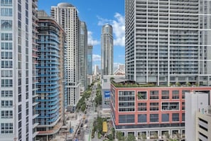 A high-rise urban area with multiple buildings, including a prominent cylindrical skyscraper and several residential high-rises. - Miami Luxe Suites (Miami)
