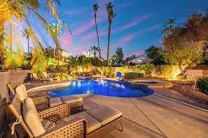 A swimming pool with lounge chairs and palm trees. - Luxury 5BR Retreat, Heated Pool, Spa, Sport Court, Putting Green & Game Rooms (Scottsdale)