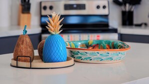 A kitchen counter with a microwave, stove, and a decorative bowl. - Luxury Beachfront Villa in Sandy Beach - Ocean View - Sleeps 9 Max. Pet-Friendly (Puerto Peñasco)