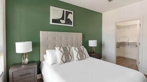 A neatly made bed with a tufted headboard, two bedside lamps, and a framed artwork above. - Landing | Stylish 2BD, Gym, Clubhouse (Goodyear)