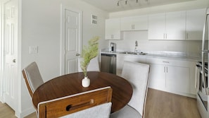 A modern kitchen with white cabinetry, a dishwasher, and a stainless steel refrigerator. - Landing | Beautiful 2BD in Bear Creek (Houston)