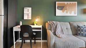 A modern living space with a desk, chair, and a sofa. - Landing | Chic Studio, Rooftop Lounge, Courtyard (Orlando)