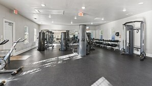 A gym with cardio equipment, weight machines, and dumbbells. - Landing | Spectacular 3BD, Gym (Fort Worth)
