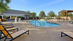 A swimming pool with lounge chairs and a pergola, surrounded by a fence and trees. - Landing | Spectacular 3BD, Gym (Fort Worth)