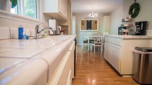 A kitchen with a stainless steel sink, a coffee maker, and a trash can. - Vintage Paso by Avantstay Firepit + Garden + BBQ Walk to Downtown Paso (Paso Robles)