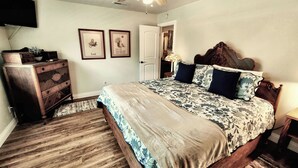 A bedroom with a wooden bed, a dresser, and two framed pictures on the wall. - Candlewood Creek by Avantstay Pool + Fire Pit Quiet Paso Cul-de-sac (Paso Robles)