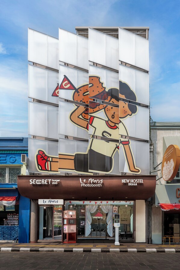 A building with a large advertisement featuring cartoon characters.
