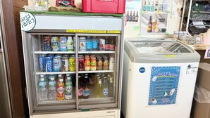 A vending machine with various drinks and a refrigerator with a menu. - Atlantis Tengachaya (Nishinari-ku, Osaka City)
