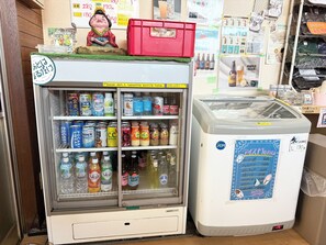 A vending machine with various drinks and a refrigerator with a menu. - Atlantis  Tengachaya (Nishinari-ku, Osaka City)