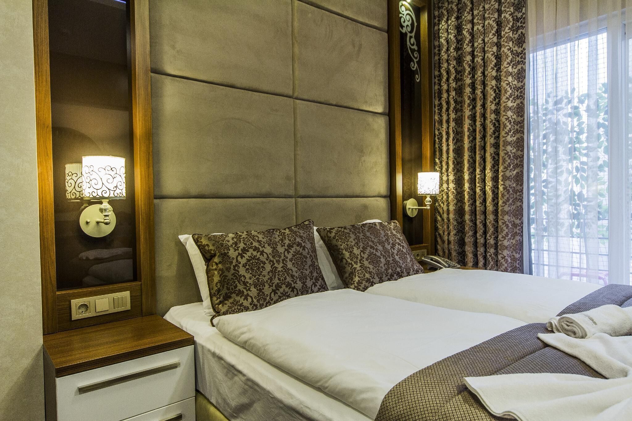 Deluxe Quadruple Room, Balcony | In-room safe, desk, blackout drapes, soundproofing