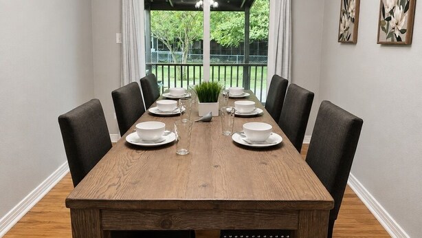 A dining room with a wooden table set for six, six black chairs, and two wall-mounted paintings. - Family-Friendly 3BR – 1 Mi to Six Flags, AT&T Stadium & Globe Life Field (Arlington)
