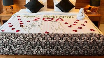 Una habitación de hotel con una cama, dos mesitas de noche y una obra de arte en la pared.