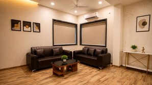 A room with two leather sofas, a wooden coffee table, and a small plant.