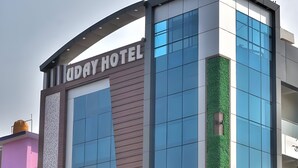 A modern hotel building with a prominent sign reading 'DAY HOTEL'.