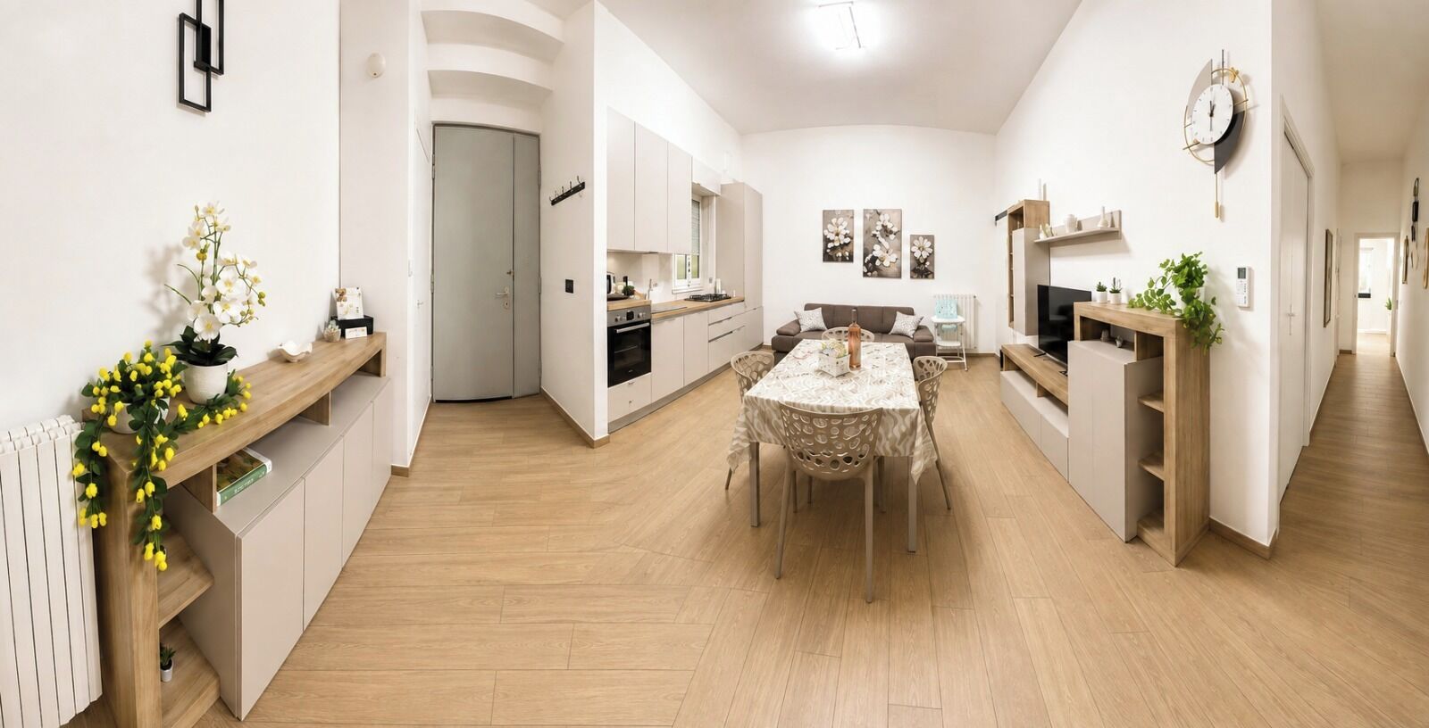 A modern interior with a dining area, kitchen, and living space.