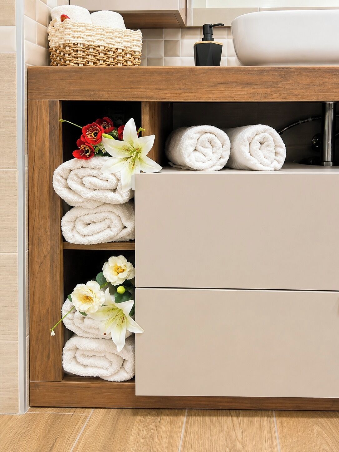 A bathroom vanity with a wooden frame, a beige countertop, and a white sink.