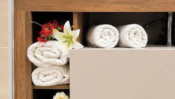A bathroom vanity with a wooden frame, a beige countertop, and a white sink.