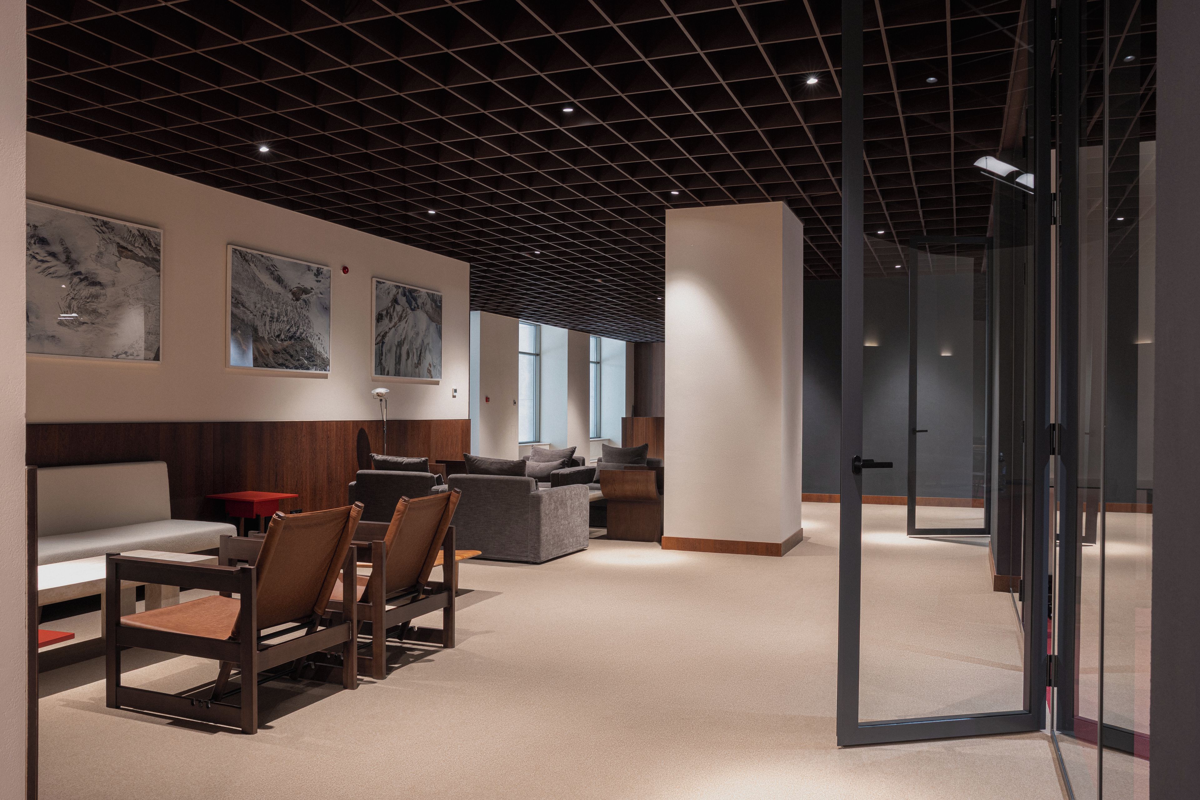 A modern interior with a dining area, seating, and artwork on the walls.