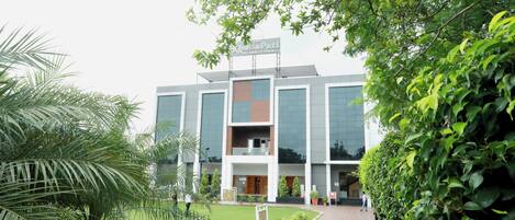 A modern building with a sign that reads 'Hotel Pati International'.