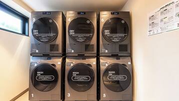 A row of six stacked laundry machines with labels indicating their functions, such as 'DRY' and 'WASH'.