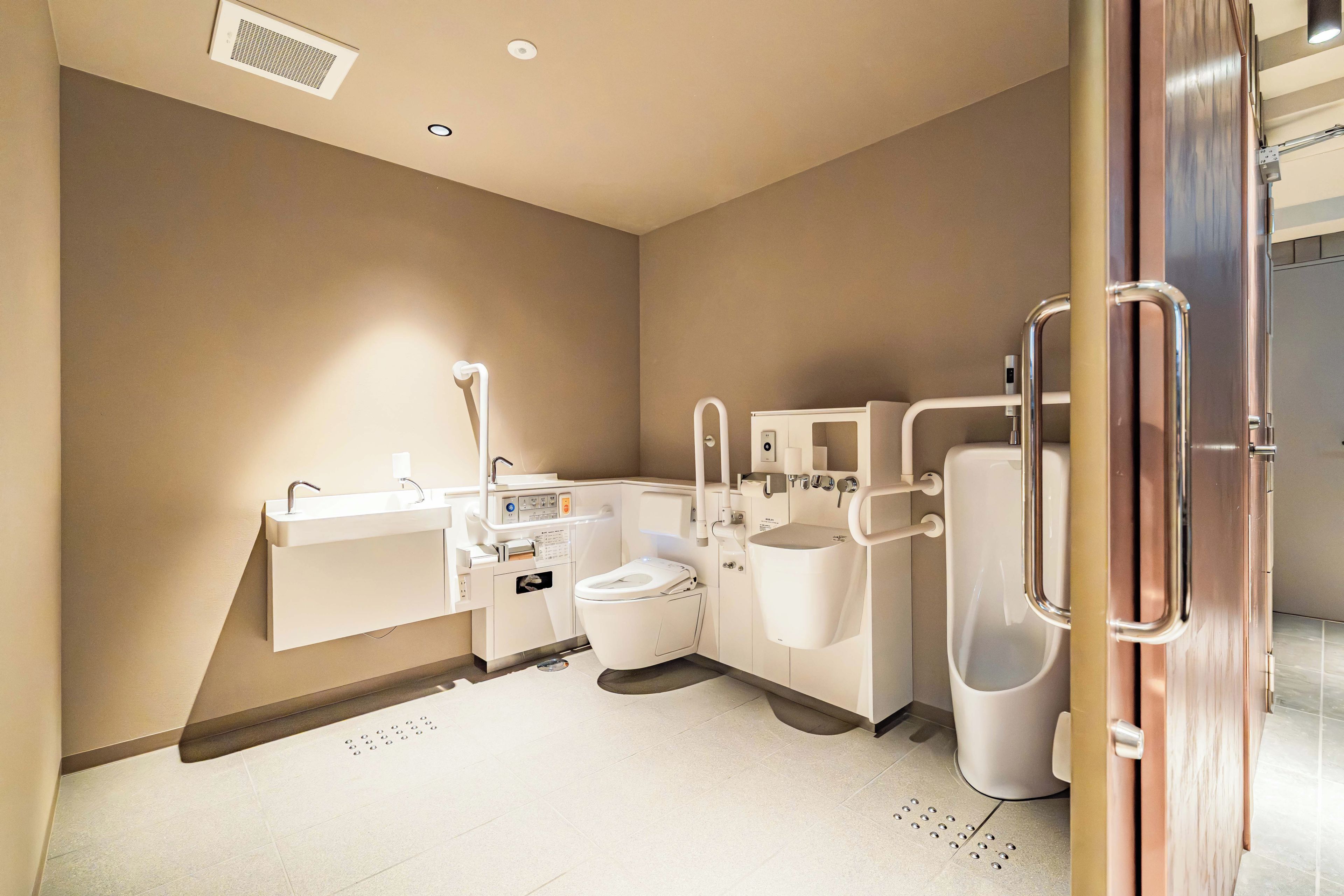 A modern bathroom with a toilet, bidet, and sink.