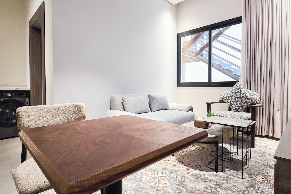Grand Apartment | Living area | 65-inch Smart TV with satellite channels