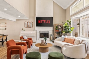 Ein Wohnzimmer mit Kamin, Fernseher und Bücherregal.
