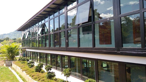 A modern building with large glass windows and a flat roof.