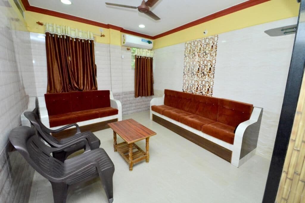 A room with two sofas, a wooden coffee table, and a ceiling fan.