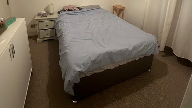 A bedroom with a bed, a nightstand, a dresser, and a ceiling light. - Charming 1-Bedroom Apartment in Central London (London)