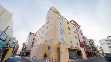A multi-story hotel with a prominent sign for 'CHARTOR HOTEL' on the ground floor.