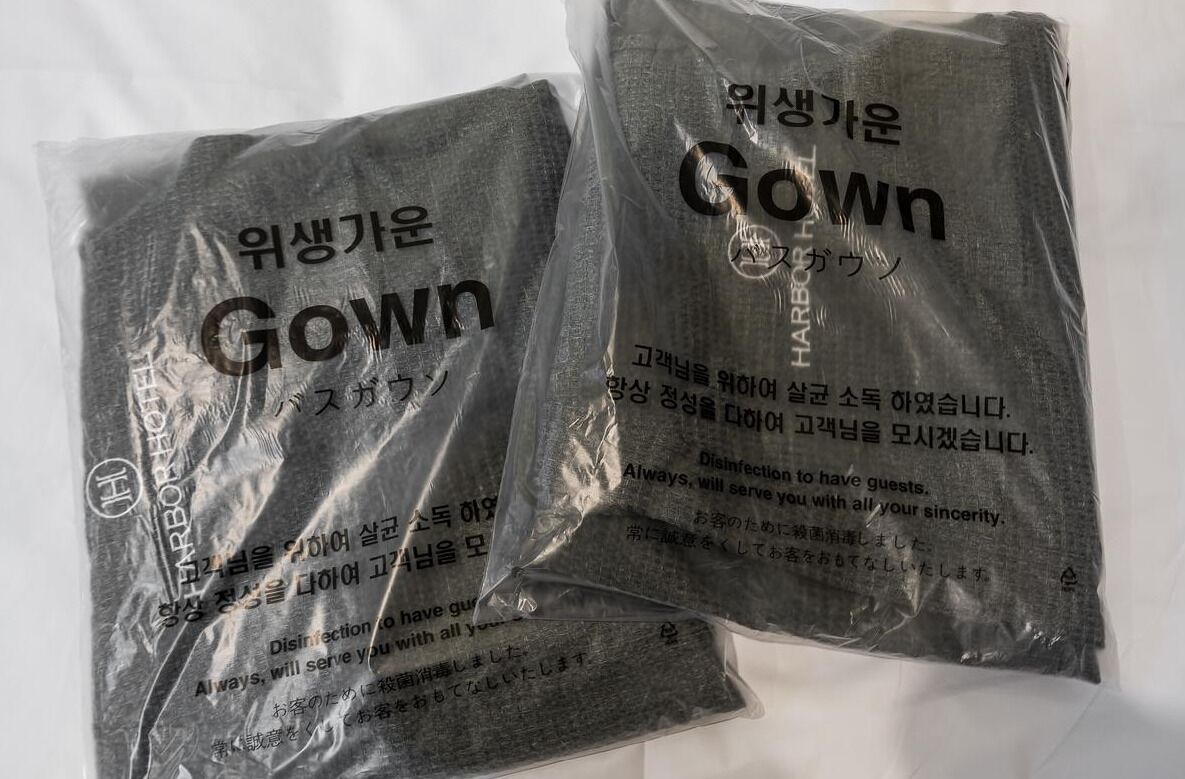 Two plastic bags with text and logos, likely containing products or supplies.