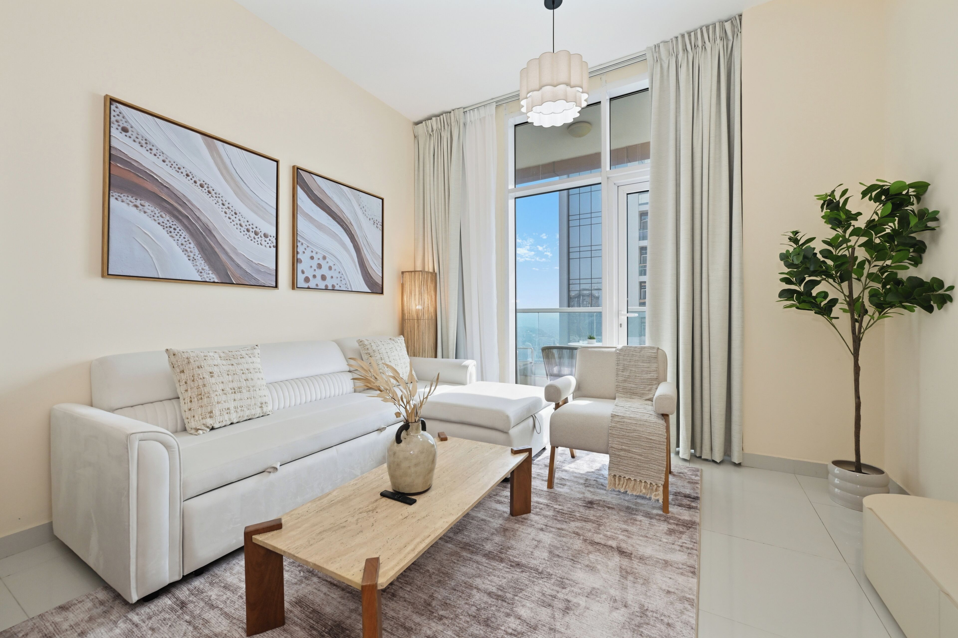 A modern living room with a sofa, armchairs, a coffee table, and a large window with curtains.