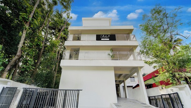 A multi-story building with a sign reading 'Collection'. - Super Collection O Valiyavila Junction (Thiruvananthapuram)